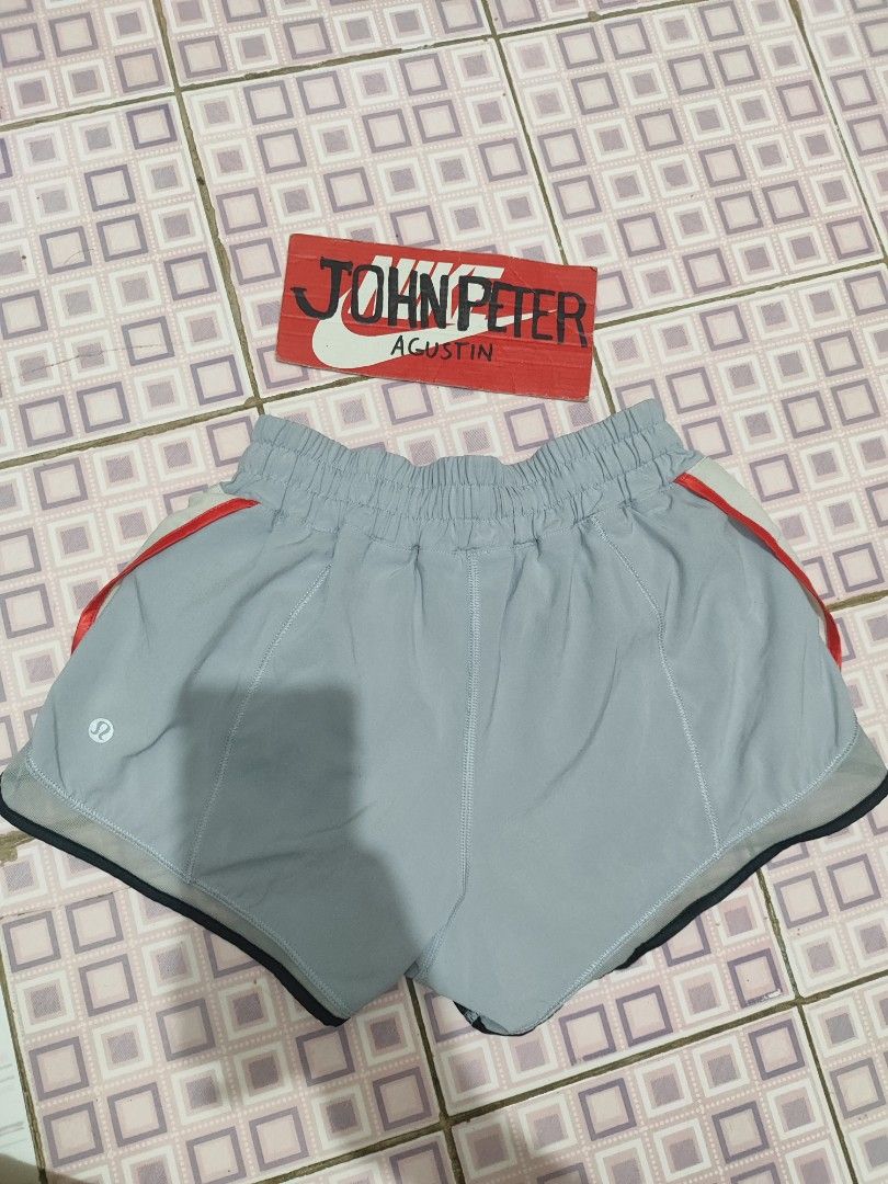 Lululemon Running Shorts Grey Blue Red Trim (Category: Activewear) located in Tuguegarao City. Submitted by johnpetera0818 (Listing ID 1450770861, Image 2). Description: - 24-32 waist 9.5 front 11.5 back Lightweight Lululemon running shorts - Color: Grey with blue and red trim details - Features an elastic waistband - Includes a small zippered pocket on the back - Built-in liner for comfort and support - Ideal for running, workouts, or everyday c