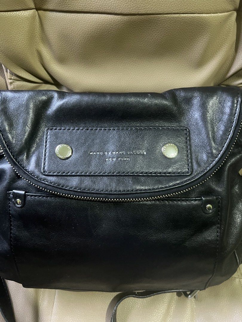 Marc by Marc Jacobs Black Leather Shoulder Bag (Category: Luxury Bags & Wallets) located in Saravia. Submitted by clynlyn (Listing ID 1450846690, Image 2). Description: - Authentic Marc by Marc Jacobs black leather shoulder bag - Front zip pocket for easy access - Secure flap closure with magnetic snaps - Interior lined with signature branded fabric - Adjustable shoulder strap for comfortable wear - Ideal everyday bag for all your essentials.