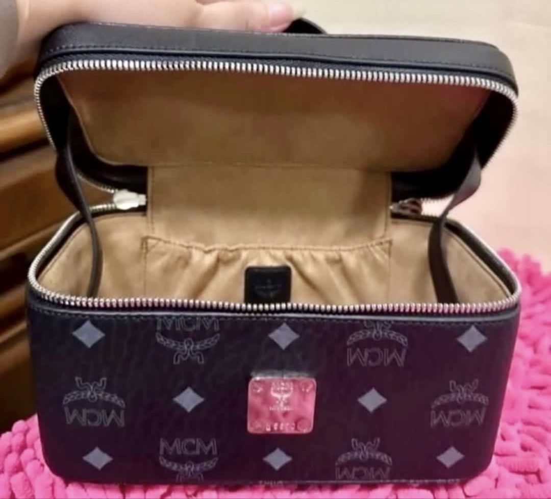 MCM vanity case with strap (Category: Cross-body Bags) located in Pasay City. Submitted by taptooload (Listing ID 1450874135, Image 1). Description: - Signature MCM logo pattern - Black exterior - Top handle - Zip-around closure - Lined interior - Detachable strap - Silver-tone hardware In great condition actual picture posted very nice in actual.