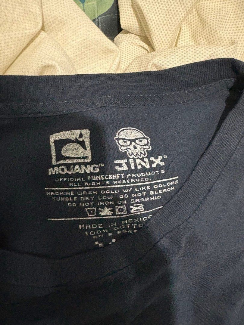 Mojang Minecraft Graphic T- Shirt (Category: Tshirts & Polo Shirts ) located in Lucena. Submitted by ryu625 (Listing ID 1450757523, Image 3). Description: W-23 L-29.5 Issues: Cracked print Slightly loose neckline.