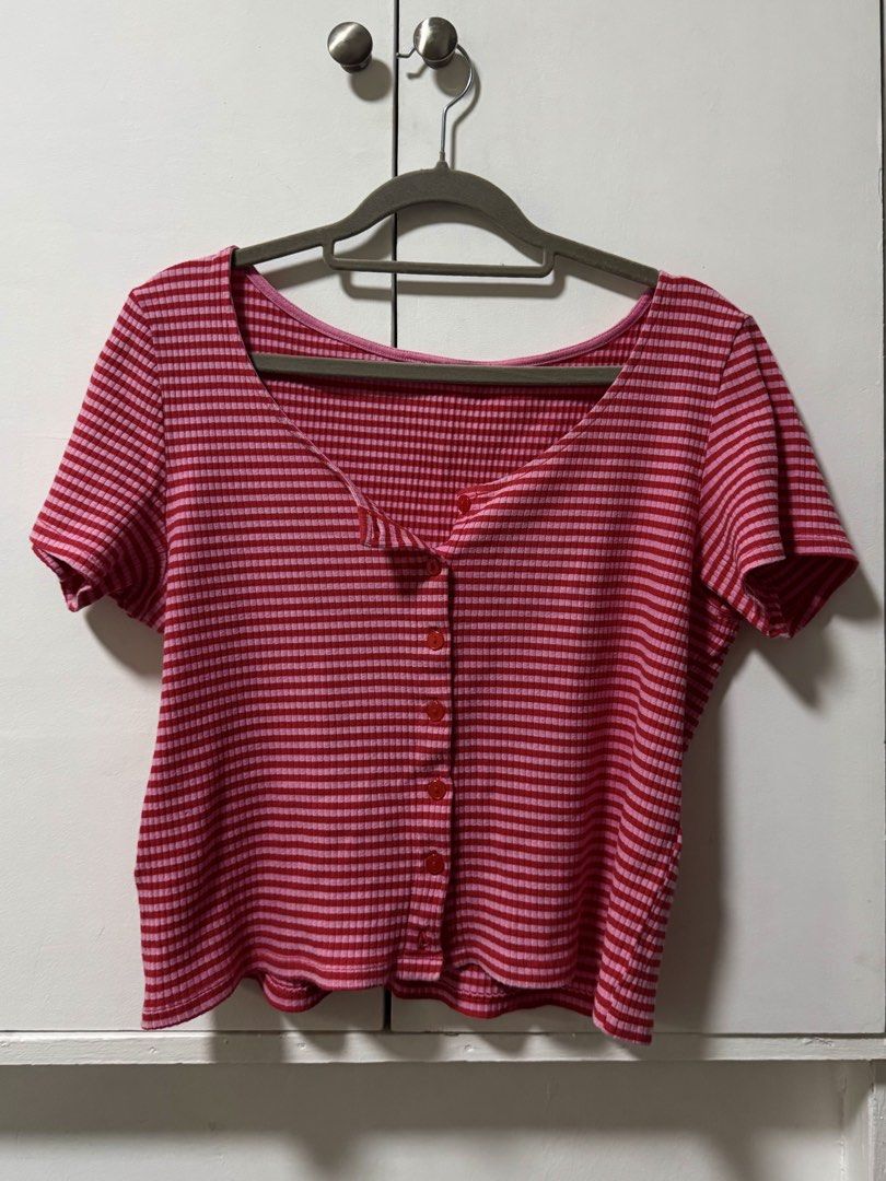 Monki Pink Red Striped Ribbed Button Up Crop Top (Category: Blouses) located in Quezon City. Submitted by nellienells (Listing ID 1450771746, Image 1). Description: - Cute pink and red striped crop top - Brand: Monki - Material: Ribbed - Features: Button-up front, short sleeves, scoop neckline - Style: Versatile for casual outings or nights out - Pair with: High-waisted jeans or skirts.