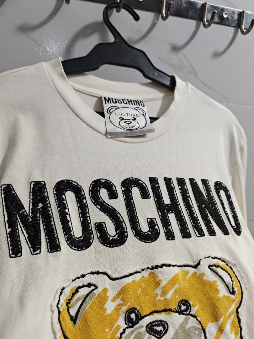 Moschino Toy Bear Unisex Tshirt (Category: Shirts) located in Baguio. Submitted by jayjay_apparel01 (Listing ID 1450897172, Image 3). Description: Moschino Toy Bear Unisex Tshirt Color Rate 9.5/10 No Flaws Complete Tags Patch And Embroidered Design Makapal Tela Cotton Machine Washed Size Large Dimes 20 Width 27 Length Price P359.