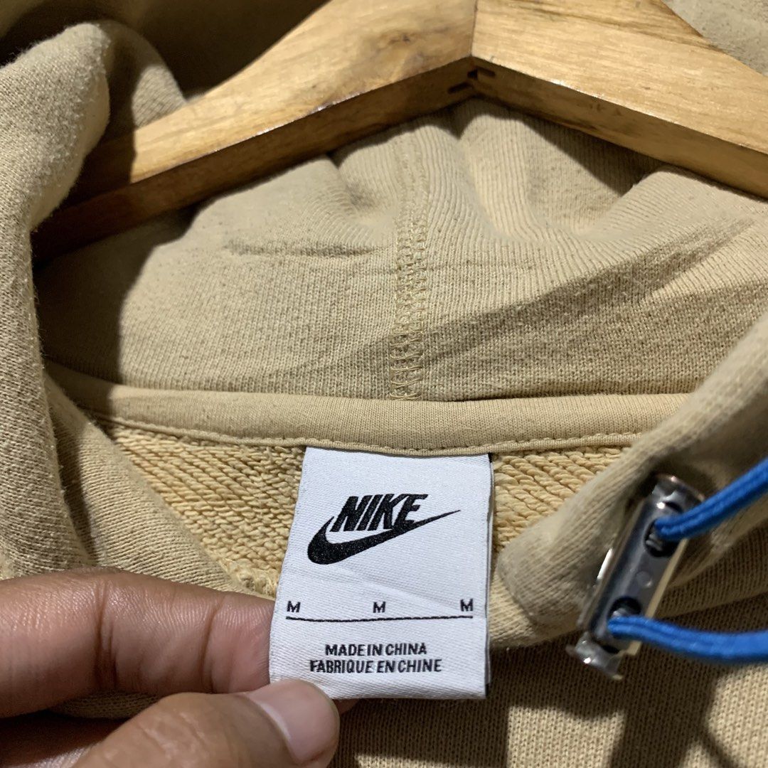 Nike Air Beige Hoodie Size M (Category: Hoodies) located in Cebu City. Submitted by stuff_paid (Listing ID 1450816938, Image 2). Description: - Beige Nike Air Hoodie - Size: Medium (M) -Width:22.5 -Length:26 - Iconic embroidered Nike swoosh and 'Air' logo on chest - Convenient front pocket - Adjustable drawstring hood - Comfortable cotton blend fabric - Ideal for everyday casual wear.