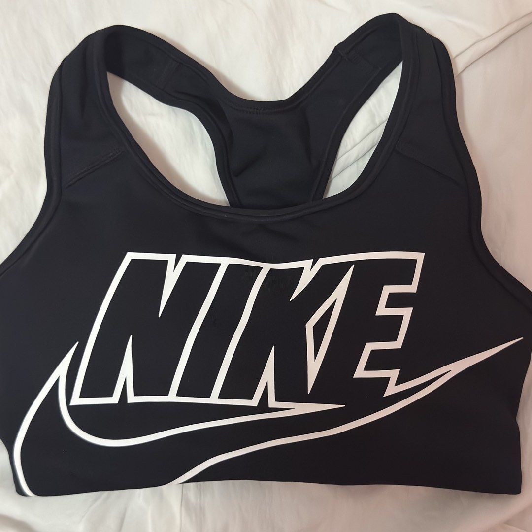 Nike Black padded Sports Bra Medium-support (Category: Activewear) located in Muntinlupa City. Submitted by decluttering22.22 (Listing ID 1450865793, Image 2). Description: - Classic black Nike sports bra - Iconic white Nike logo on front - Racerback design for enhanced support - Ideal for workouts.