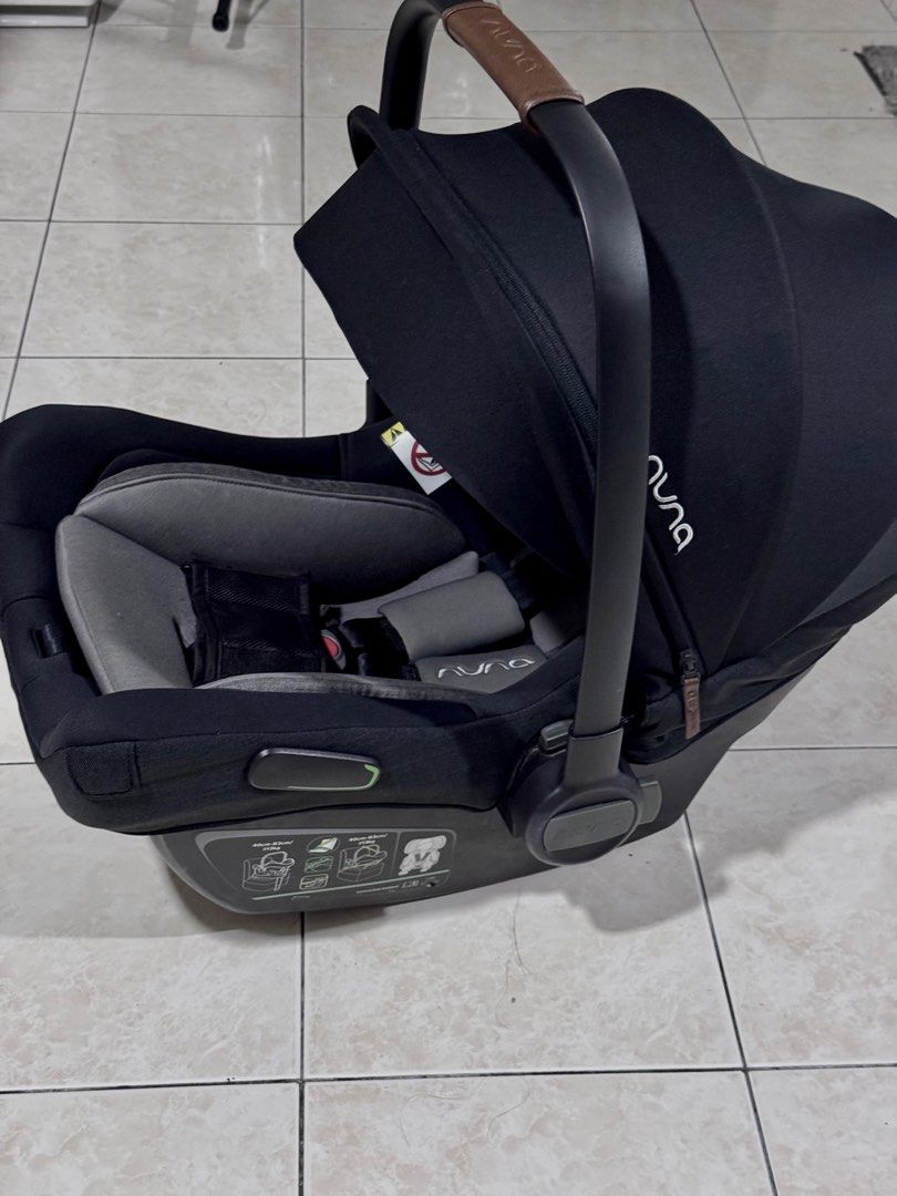 Nuna Pipa Next (Caviar) Infant Car Seat (Category: Car Seats) located in Sungai Buloh. Submitted by barangbaik24 (Listing ID 1450911973, Image 2). Description: - Nuna Pipa infant car seat - Color: Black with grey padding - Adjustable canopy for sun protection - Secure harness system for safety - Easy-carry handle for portability - Ideal for travel and everyday use - Clean and well-maintained - No box.