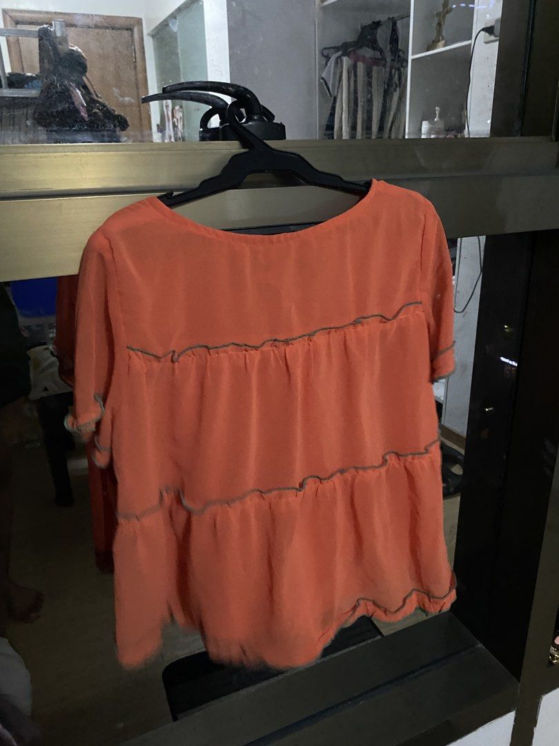 Orange Tiered Short Sleeve Top (Category: Blouses) located in Taguig. Submitted by aerish_declutter (Listing ID 1450871096, Image 2). Description: - Chic orange top with short sleeves - flowy top.