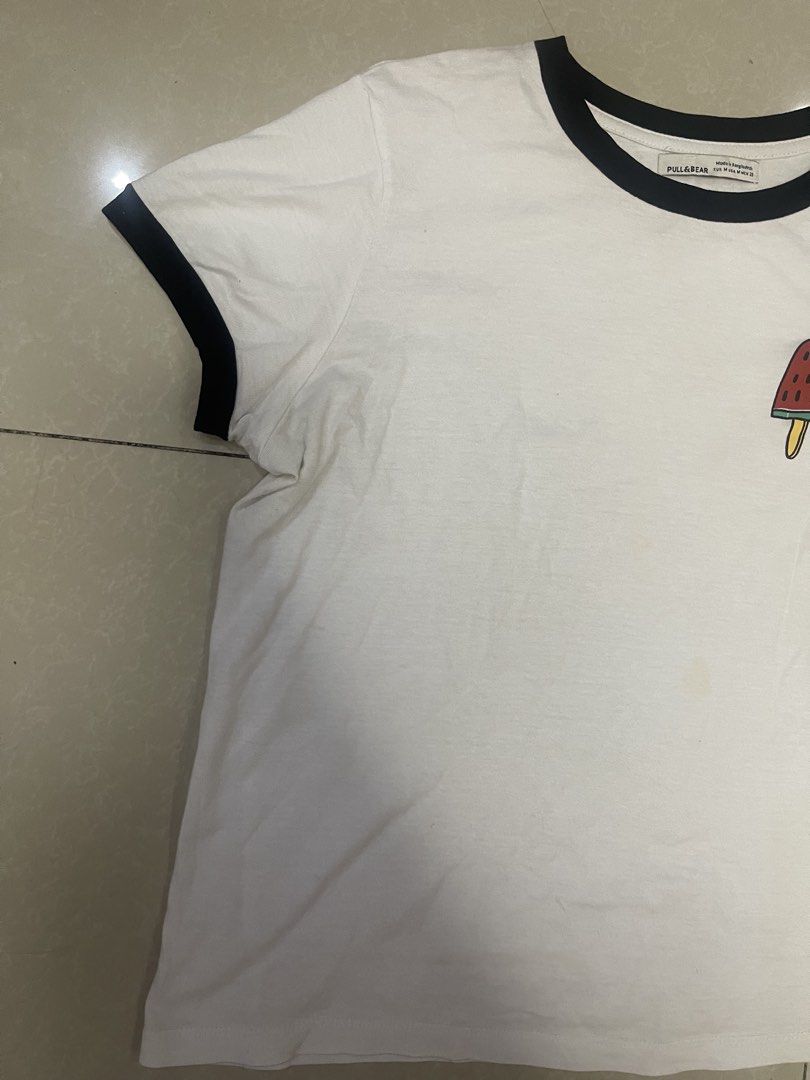 Pull & Bear White T-shirt with Popsicle Graphic (Category: Tshirts & Polo Shirts ) located in Manila. Submitted by offtherack_mnl (Listing ID 1450893692, Image 3). Description: - White ringer tee from Pull & Bear - Features a cute popsicle graphic on the chest - Black trim on collar and sleeves - Perfect for a casual look.