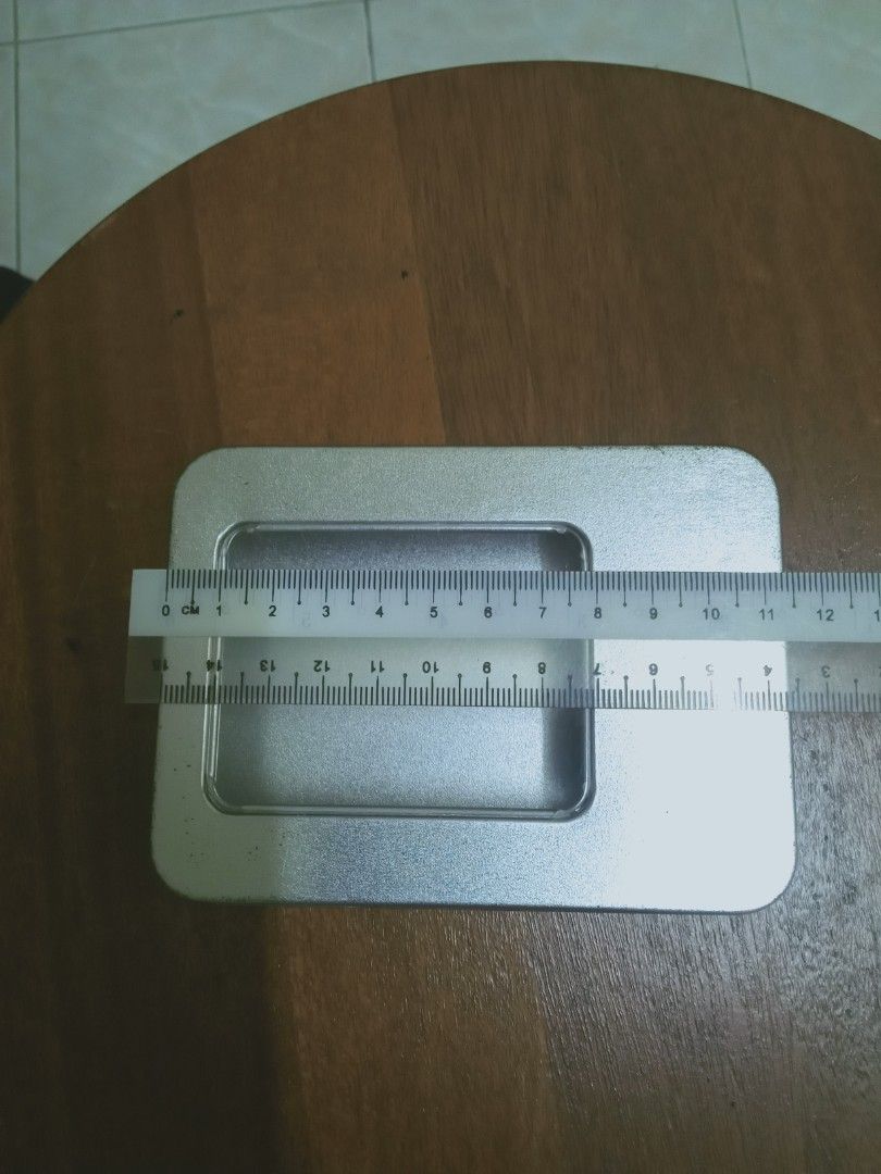 Rectangular Tin Box with Window (Category: Magazines) located in Rawang. Submitted by pasarkaratonline90 (Listing ID 1450768893, Image 3). Description: - Sleek silver rectangular tin box - Features a clear window on the lid for easy viewing - Ideal for organizing small items, crafts, or as a charming gift box - Approximate dimensions: 14.5 cm (length) x 9.5 cm (width) - Comes empty, ready for your personal touch or storage needs - Inquire if you 