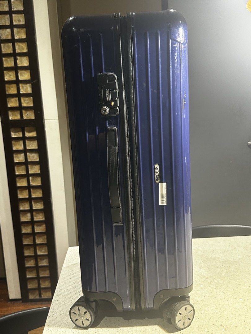 Rimowa Check In Luggage (Category: Luggage) located in Muntinlupa City. Submitted by goodsbymjp (Listing ID 1447106293, Image 2). Description: - Classic blue Rimowa suitcase with iconic ribbed design. - Shows expected signs of wear from travel, adding character. - Wheels are intact and fully functional, ready to roll. - Perfect for short trips or as a convenient carry-on. -with crack photo at last part but not obvious and not an issue with the fu