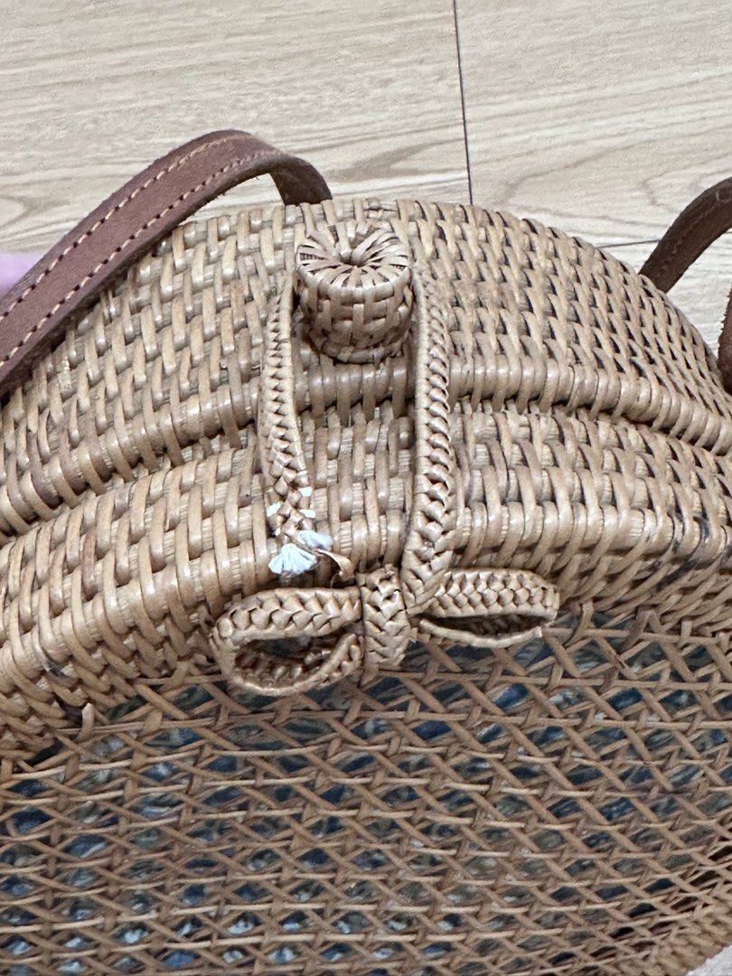 Round Rattan Bag with Blue Floral Lining (Category: Cross-body Bags) located in Binan City. Submitted by forgetmenot_ph (Listing ID 1450854614, Image 3). Description: - Cute round rattan bag - Lovely blue and white floral fabric lining - Brown leather strap - Braided closure detail with a small tassel - Ideal for beach trips or casual outings - Bought in Bali - Flaw: see last photo.
