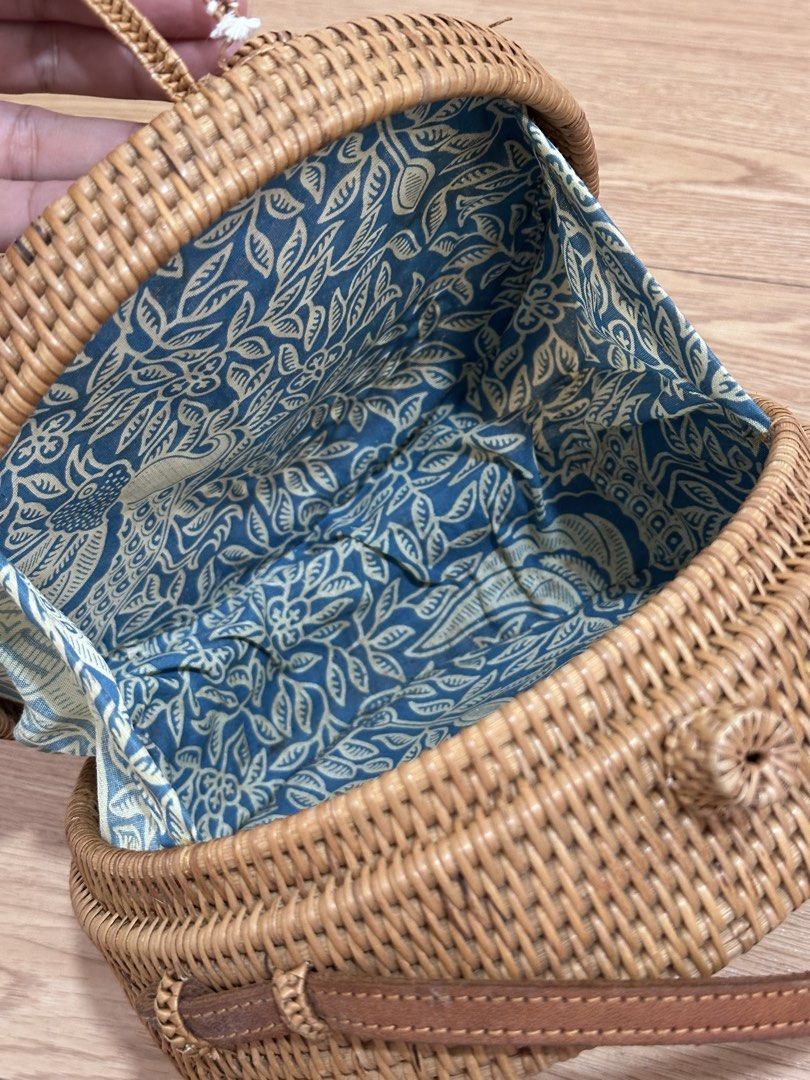 Round Rattan Bag with Blue Floral Lining (Category: Cross-body Bags) located in Binan City. Submitted by forgetmenot_ph (Listing ID 1450854614, Image 2). Description: - Cute round rattan bag - Lovely blue and white floral fabric lining - Brown leather strap - Braided closure detail with a small tassel - Ideal for beach trips or casual outings - Bought in Bali - Flaw: see last photo.