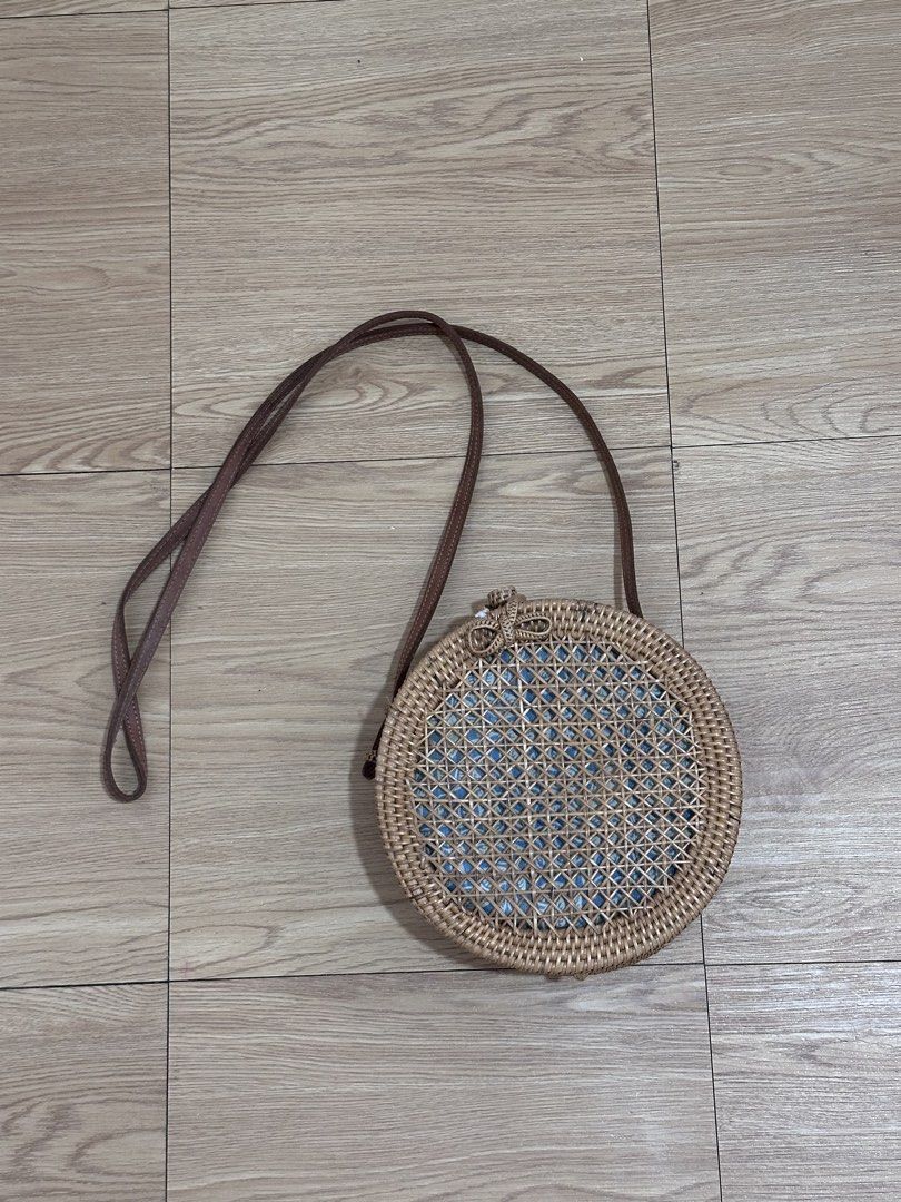 Round Rattan Bag with Blue Floral Lining (Category: Cross-body Bags) located in Binan City. Submitted by forgetmenot_ph (Listing ID 1450854614, Image 1). Description: - Cute round rattan bag - Lovely blue and white floral fabric lining - Brown leather strap - Braided closure detail with a small tassel - Ideal for beach trips or casual outings - Bought in Bali - Flaw: see last photo.