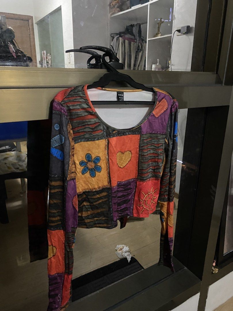 SHEIN Patchwork Long Sleeve Crop Top (Category: Longsleeves) located in Taguig. Submitted by aerish_declutter (Listing ID 1450870787, Image 1). Description: - Cute patchwork long sleeve crop top - Colorful design with flower, sun, and heart prints - Estimated size: S - Ideal for a casual, artsy vibe - Great for layering or wearing solo.
