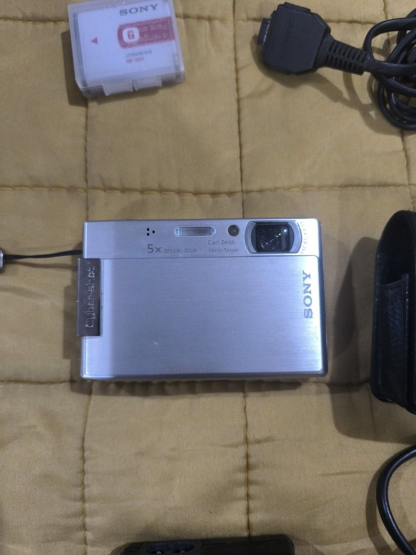 Sony Cyber-shot DSC-T70 Digital Camera with Accessories (Category: Cameras) located in Manila. Submitted by matchpoint (Listing ID 1450900939, Image 2). Description: PRELOVED AND LIGHTLY-USED ALL ORIGINAL SOLD IN ONE SET - Silver Sony Cyber-shot DSC-T70 digital camera - Includes original case, charger, and 2 pieces of battery, connector - Comes with a SONY mini tripod - Tested and working perfectly RFS: decluttering.