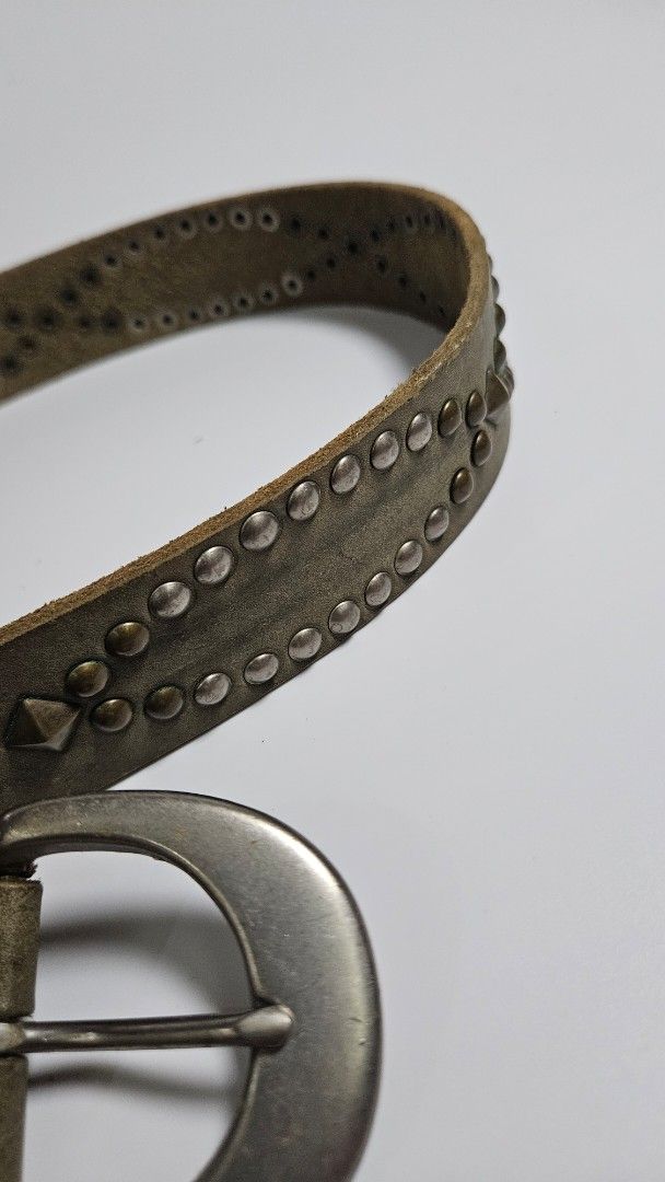 Studded Leather Belt with Silver Buckle (Category: Belts) located in Alfonso. Submitted by jbcamet (Listing ID 1450841383, Image 2). Description: - Stylish distressed leather belt - Accented with silver studs - Classic silver-tone buckle - Adjustable fit with spaced holes - Adds an edgy touch to any outfit.