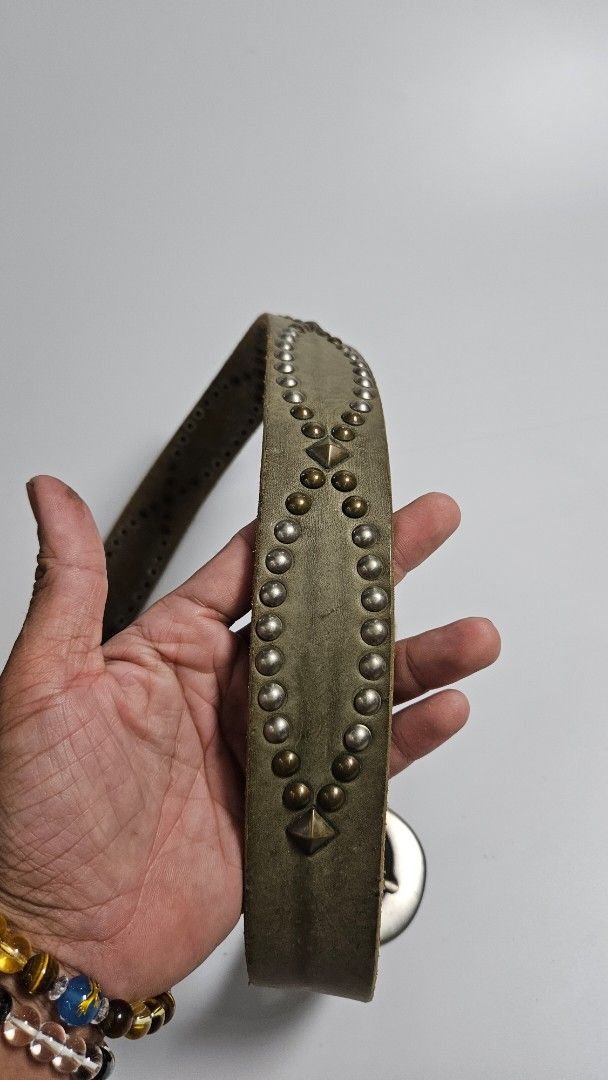 Studded Leather Belt with Silver Buckle (Category: Belts) located in Alfonso. Submitted by jbcamet (Listing ID 1450841383, Image 3). Description: - Stylish distressed leather belt - Accented with silver studs - Classic silver-tone buckle - Adjustable fit with spaced holes - Adds an edgy touch to any outfit.