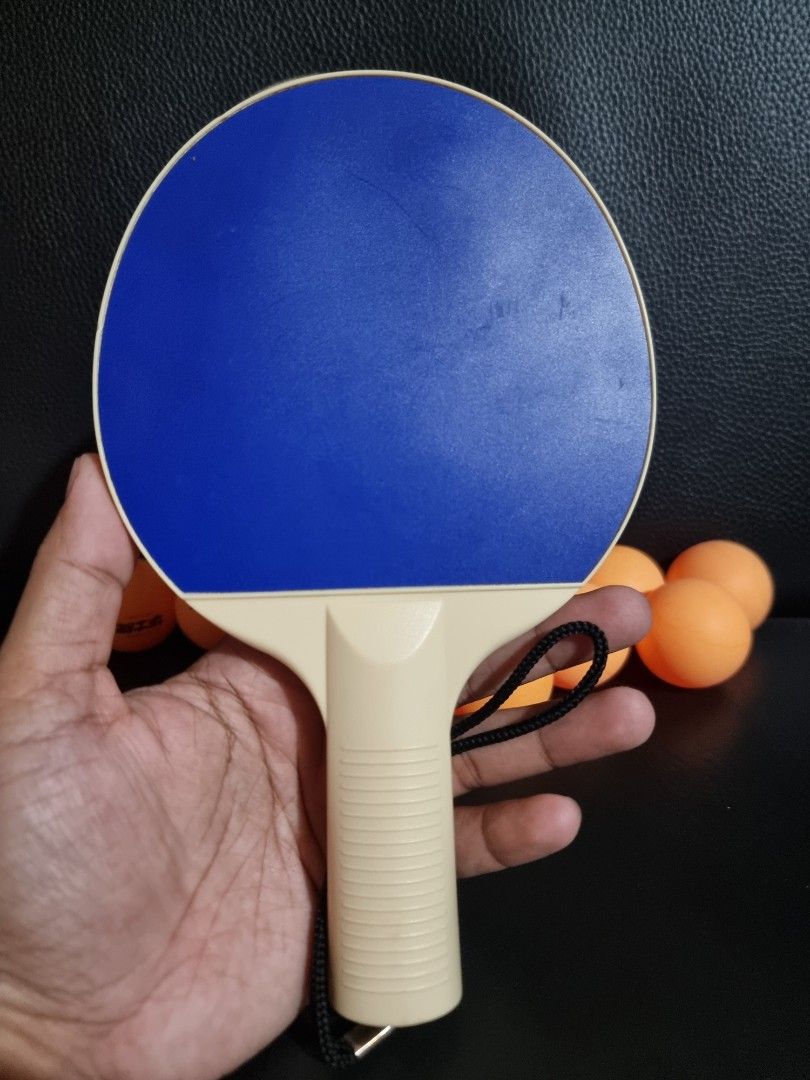 Table Tennis Paddles and 12 Balls Set (Category: Racket and Ball Sports) located in Imus. Submitted by aim_for_less (Listing ID 1450896159, Image 3). Description: - Set includes 2 table tennis paddles (1 red, 1 blue) - Comes with 12 standard-sized orange table tennis balls - Ideal for casual play and recreational fun - Paddles feature comfortable grips for better control - Includes wrist straps for added security during play.