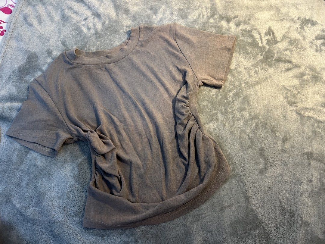 Taupe Ruched Side T-shirt (Category: Other Tops) located in Kuala Lumpur. Submitted by lyliakly (Listing ID 1450774975, Image 1). Description: - Casual taupe t-shirt - Features a stylish ruched detail on one side - Soft and stretchy fabric for ultimate comfort - Classic crew neck and short sleeves - Versatile for everyday wear - Easily pairs with jeans, shorts, or skirts.