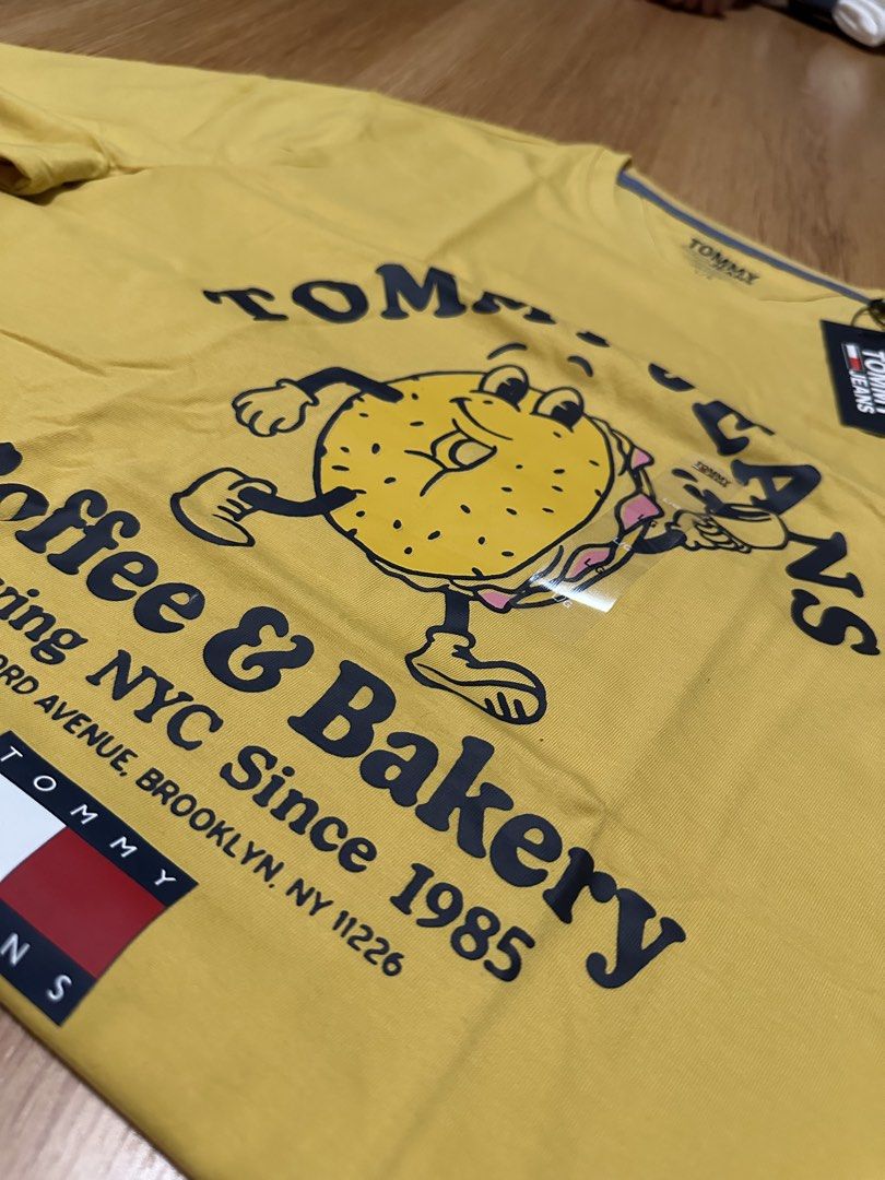Tommy Jeans Graphic T-Shirt (Category: Tshirts & Polo Shirts ) located in Quezon City. Submitted by atanashii (Listing ID 1450824859, Image 2). Description: - Brand new Tommy Jeans t-shirt - Size: Large (L) - Fun 'Coffee & Bakery' graphic with a donut character - Brooklyn, NY detail on graphic - Regular fit - Perfect for casual wear - Still has original tags attached Negotiable Rfs: not into these types of shirts anymore .