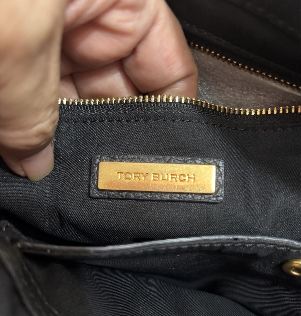Tory Burch Black Leather Tote Bag with Shoulder Strap (Category: Luxury Bags & Wallets) located in Indang. Submitted by lornacmtl (Listing ID 1450781205, Image 3). Description: - Genuine black leather Tory Burch tote bag - Includes a detachable shoulder strap - Elegant gold hardware details - Spacious interior for all your essentials - Ideal for everyday use.