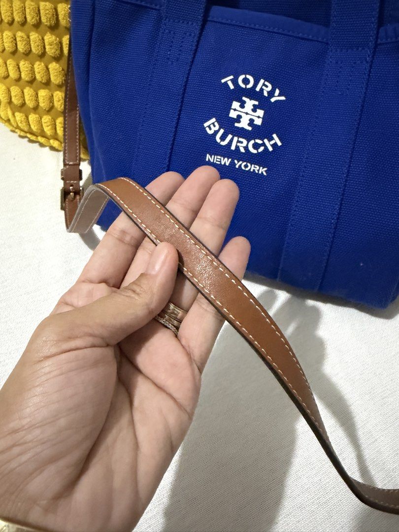 Tory Burch Canvas Tote Bag Blue (Category: Luxury Bags & Wallets) located in Paranaque City. Submitted by mweowmyganda (Listing ID 1450862424, Image 2). Description: - Blue Tory Burch canvas tote bag - Genuine leather handles and strap - Interior slip pocket for organization - 'Tory Burch New York' logo on the front - Made in India - Ideal for everyday use Hardware: gold tone stainless steel, polish finished Exterior: printed white logo Interior: