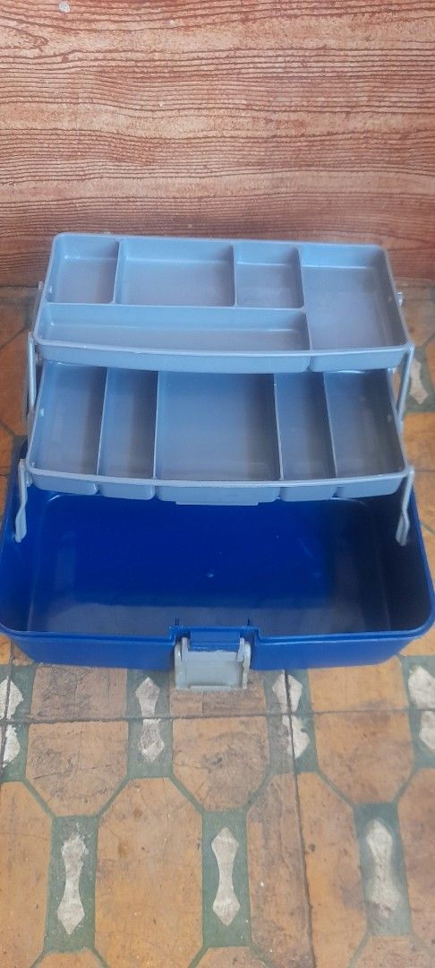 UNIT Blue and Grey Plastic Tackle Box Organizer (Category: Storage Boxes & Baskets) located in Valenzuela. Submitted by newbear.425b6e (Listing ID 1450813571, Image 3). Description: - Blue and grey plastic organizer box - Multiple compartments for small items - Top tray lifts up for additional storage - Built-in handle for easy portability - Ideal for tools, crafts, or fishing gear - Approximate dimensions: 12" L x 7" W x 7" -surplus .