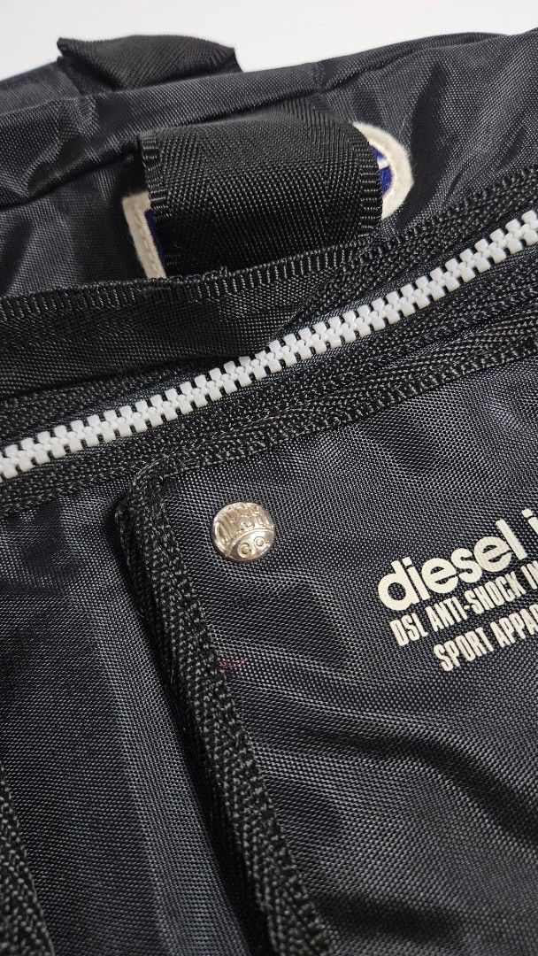 vintage Diesel multi pocket tactical utility bag (Category: Luxury Bags & Wallets) located in Alfonso. Submitted by jbcamet (Listing ID 1450849732, Image 3). Description: - Black Diesel bag - Bright orange interior lining - Silver zippers and clasps - Red accents on zipper pulls - Ideal for carrying essentials.