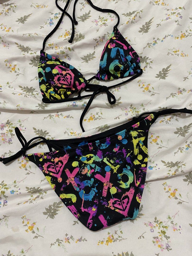 Vintage ROXY "Out Loud" Neon Graffiti Reversible Bikini Set (Category: Bikinis & Swimsuits) located in Marilao. Submitted by kyssmarila (Listing ID 1450871922, Image 2). Description: — Size: XS • “R” and “O”: Placed individually onto each triangle cup of the bra top. • “X”: Centered boldly right across the front panel of the bikini bottom. • “Y”: Printed on the reverse back panel of the bottom to complete R-O-X-Y. early 2000s surf-babe look with 
