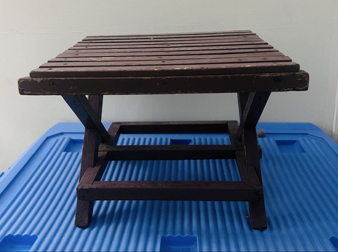Vintage Wooden Stool Side Table (Category: Chairs) located in Pasig City. Submitted by mavrugbys_123 (Listing ID 1450847977, Image 1). Description: - Compact wooden stool in dark brown. - Versatile: Use as extra seating or a small side table. - Folds flat for convenient storage. - Sturdy construction with minor cosmetic scuffs from use. - Ideal for camping, picnics, or everyday home use..