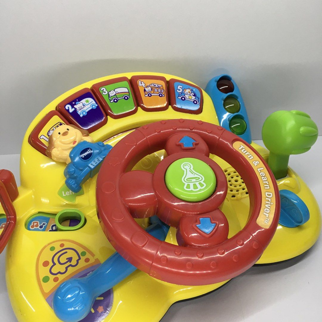 VTech Turn & Learn Driver Toy Steering Wheel (Category: Infant Playtime) located in Quezon City. Submitted by goodz4good (Listing ID 1450794899, Image 3). Description: - VTech Turn & Learn Driver toy - Lots of interactive buttons and sounds - Features a steering wheel, gear shifter, and traffic lights - Encourages motor skill development and learning about vehicles - Batteries not included mode of payment gcash cash or cod meet up available free 