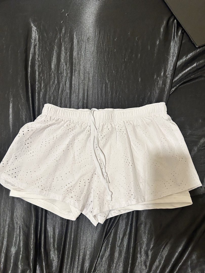 White Eyelet Double Layer Running Shorts (Category: Shorts) located in Manila. Submitted by declutteringmpc (Listing ID 1450842347, Image 1). Description: - Chic white shorts with delicate eyelet overlay - Double-layer design for comfort and coverage (built-in shorts included) - Easy-to-wear elastic waistband with adjustable drawstring - Versatile: Ideal for workouts, casual outings, or lounging - Made with breathable, comfortable fabric.