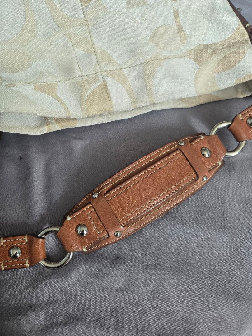 Y2k Coach Carly Optic Hobo Bag Medium (Category: Luxury Bags & Wallets) located in Manila. Submitted by shla.dln (Listing ID 1450829975, Image 2). Description: - Authentic Coach shoulder bag - Signature monogram canvas - Tan leather trim and strap - Silver hardware with turn-lock closure - Classic, versatile design - Ideal for daily use.