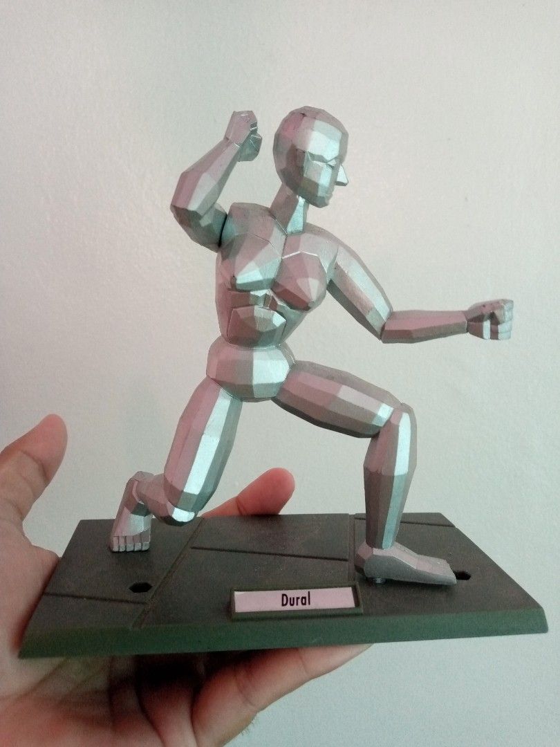 1993 Sega Virtua Fighter Silver Figure Model "Dural" on Base (Category: Figurines & Statues) located in General Trias. Submitted by dwyane09 (Listing ID 1450957766, Image 3). Description: - Silver figure model - Includes dark base with 'Dural' label - Movable joints for versatile posing - Ideal for artists and collectors - Made in China - Some text present on the back of the figure.
