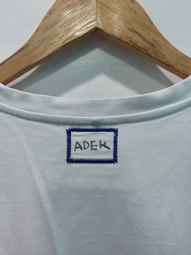 ADER Error White Embroidered Logo T-Shirt Size A2 (Category: Tshirts & Polo Shirts ) located in Quezon City. Submitted by lancelooot (Listing ID 1451009989, Image 3). Description: - Brand: ADER Error - Color: Off-white - Size: A2 (22x28) - Collection: 2021 Spring Summer - Front Detail: Embroidered multi-color 'ADER' logo - Back Detail: Small embroidered logo near collar - Material: 75% Cotton, 25% Polyester.