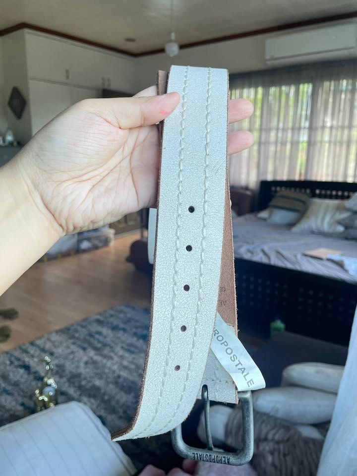 Aeropostale Genuine Leather Belt (Category: Belts) located in Cainta. Submitted by pnedp2022 (Listing ID 1450991073, Image 3). Description: - Aeropostale Belt - Genuine Leather - Length: 44 inches - Color: Light Beige/Off-White with Tan Stitching - Buckle: Silver-toned Metal - Condition: Excellent 9.5/10 - Loc: Greenwoods Pasig/Cainta.