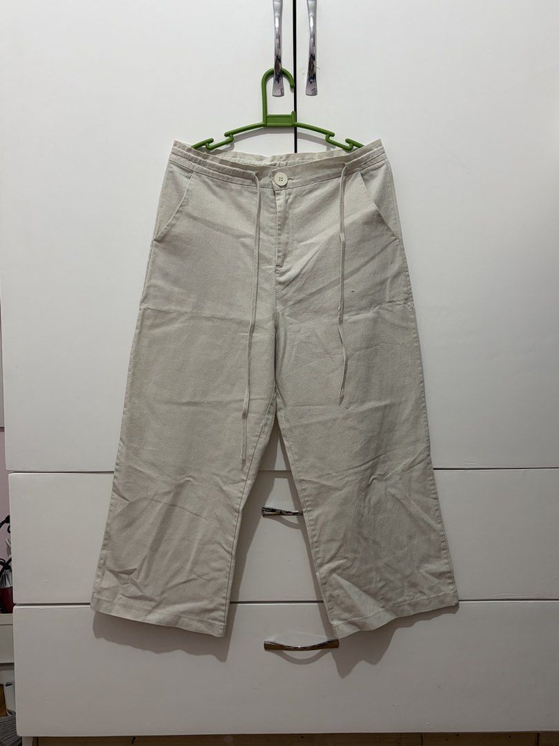 Beige Wide Leg Cropped Pants with Drawstring Waist (Category: Other Bottoms) located in Angeles City. Submitted by um4ru222 (Listing ID 1451109636, Image 1). Description: - Casual beige pants - Wide leg, cropped length - Adjustable drawstring waist - Two side pockets - Front button and zip closure - Ideal for everyday wear and easy styling.