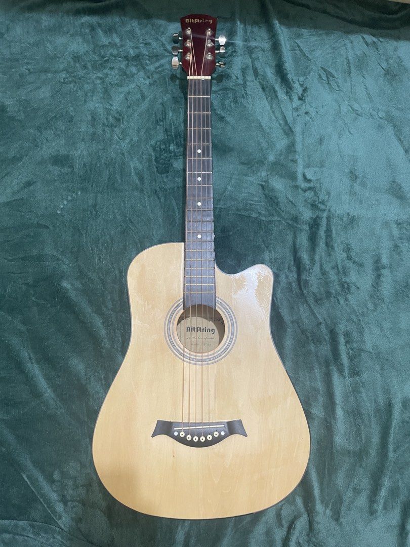 Bitstring Acoustic Guitar - Natural Wood Finish (Category: Musical Instruments) located in Mabalacat. Submitted by mnaniii (Listing ID 1451052583, Image 1). Description: - Bitstring acoustic guitar - Natural wood top with red stained back and sides - Cutaway body style - 6 strings - Ideal for beginners or reliable everyday playing - Tuners located on the headstock - Ready for strumming and immediate use Delivery Can do meetup around bulacan .
