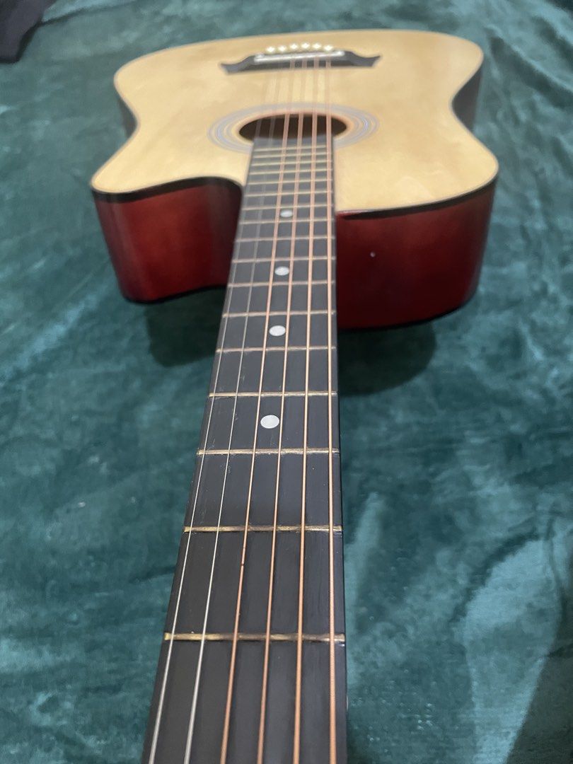 Bitstring Acoustic Guitar - Natural Wood Finish (Category: Musical Instruments) located in Mabalacat. Submitted by mnaniii (Listing ID 1451052583, Image 2). Description: - Bitstring acoustic guitar - Natural wood top with red stained back and sides - Cutaway body style - 6 strings - Ideal for beginners or reliable everyday playing - Tuners located on the headstock - Ready for strumming and immediate use Delivery Can do meetup around bulacan .