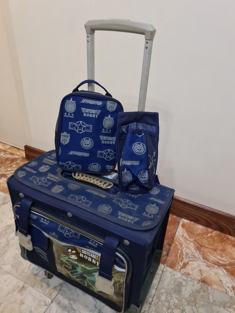 Blue Rolling Backpack with Matching Pouches (Category: Backpacks) located in Manila. Submitted by lc_declut (Listing ID 1451058761, Image 1). Description: - Robby the Rabbit - Fun blue rolling backpack with robot and airplane design. - Includes two matching pouches. - Features wheels and a retractable handle for easy transport. - Plenty of interior space for school books and supplies. - Durable material, great for kids carrying their gear. - Show