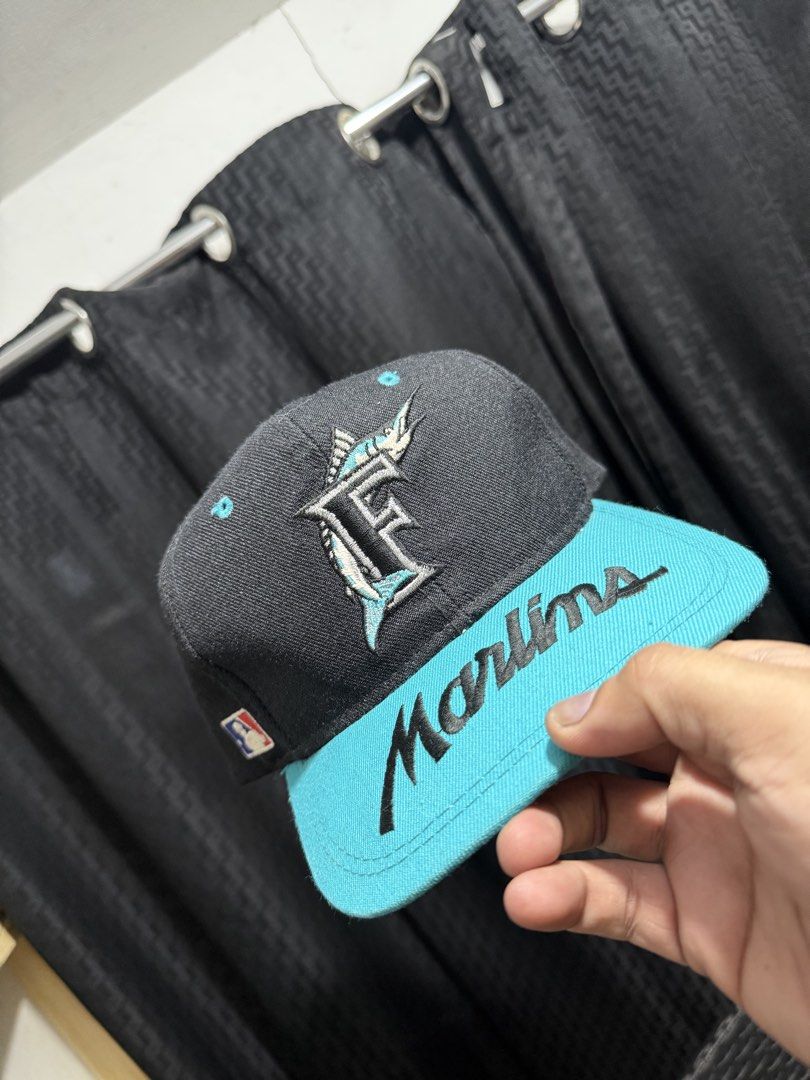 BRIM script Florida Marlins Sports Specialties Snapback Hat (Category: Caps & Hats) located in Pasay City. Submitted by lenesiesph08647 (Listing ID 1451010571, Image 2). Description: - Vintage Florida Marlins hat - Black with teal brim and logo - Features the Marlins script on the front - Made by Sports Specialties - One size fits all snapback style - Perfect for any Marlins fan!.