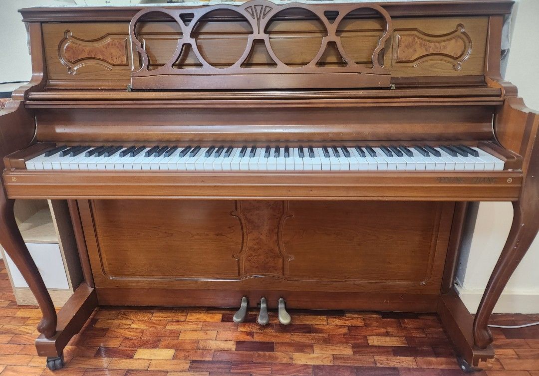 Brown Upright Piano with Bench (Category: Musical Instruments) located in Pasig City. Submitted by swifttiger_9ce6a2 (Listing ID 1451054788, Image 2). Description: - Elegant upright piano with a classic wooden finish. - Comes with a charming pink quilted bench. - Keys and internal mechanism clearly visible in photos. - Ideal for piano practice or as a stylish display item. - Buyer must arrange for pickup. - korea best brand 'youngchang'.