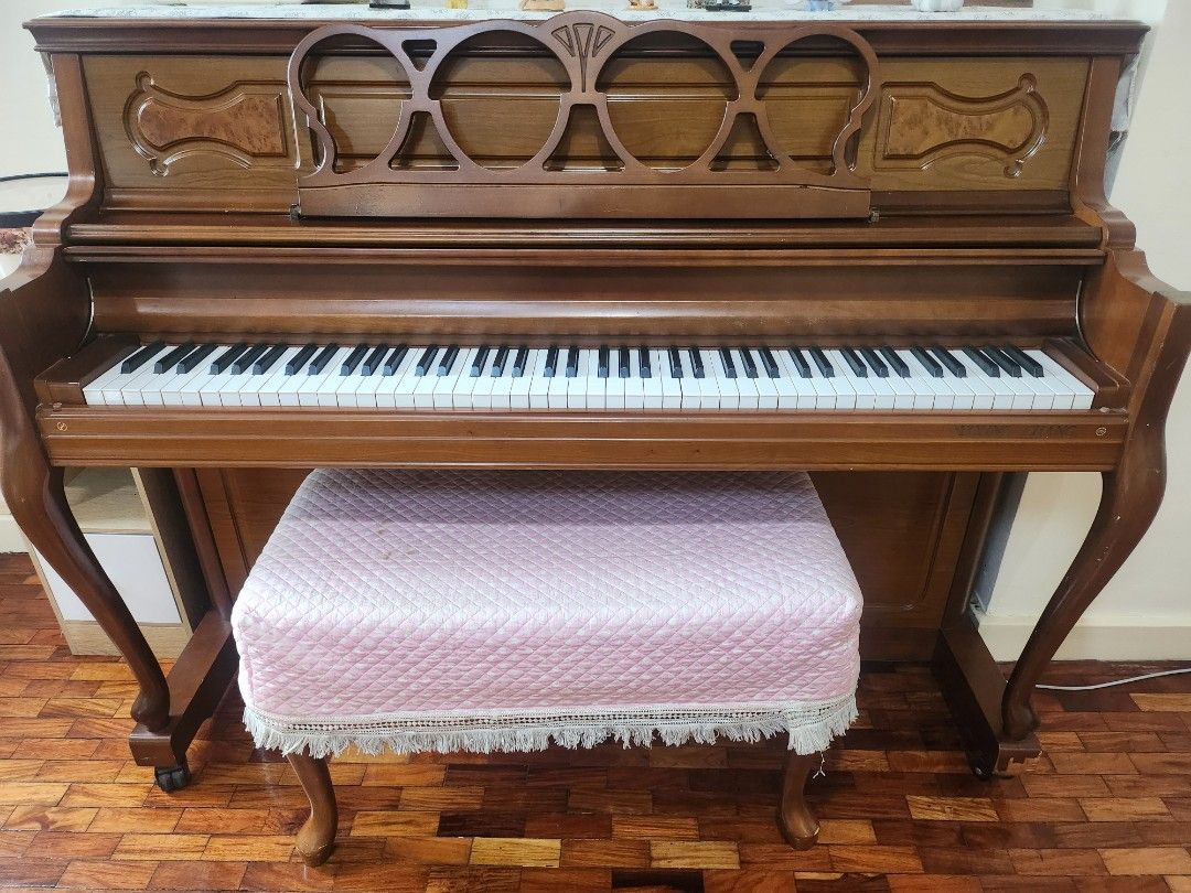 Brown Upright Piano with Bench (Category: Musical Instruments) located in Pasig City. Submitted by swifttiger_9ce6a2 (Listing ID 1451054788, Image 1). Description: - Elegant upright piano with a classic wooden finish. - Comes with a charming pink quilted bench. - Keys and internal mechanism clearly visible in photos. - Ideal for piano practice or as a stylish display item. - Buyer must arrange for pickup. - korea best brand 'youngchang'.
