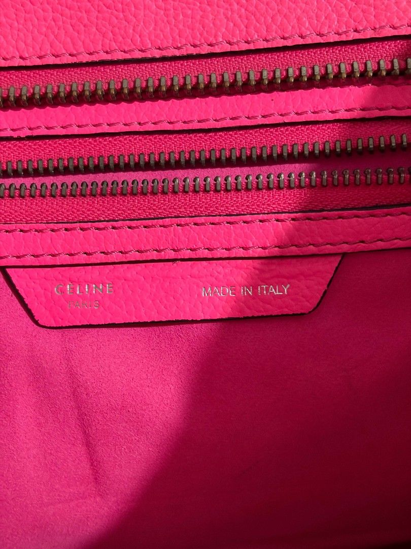 Celine Neon Pink Leather Top Handle Bag (Category: Luxury Bags & Wallets) located in Manila. Submitted by preciousma24494 (Listing ID 1451052595, Image 2). Description: - Eye-catching neon pink Celine bag - Made in Italy craftsmanship - Genuine leather exterior - Interior zippered compartments for organization - Convenient front zip pocket - Stylish metal hardware details on corners - Comfortable top handles for carrying - Perfect statement acces