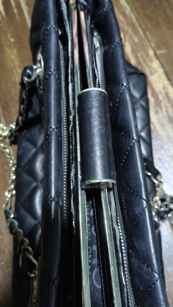 Chanel Shoulder Bag (Category: Luxury Bags & Wallets) located in Quezon City. Submitted by morningstar_52 (Listing ID 1451107297, Image 3). Description: - Black quilted leather Chanel shoulder bag - Prominent patent leather CC logo - Silver chain straps - Multiple interior compartments and zippered pockets - Some wear on interior lining and edges - Classic and timeless design.