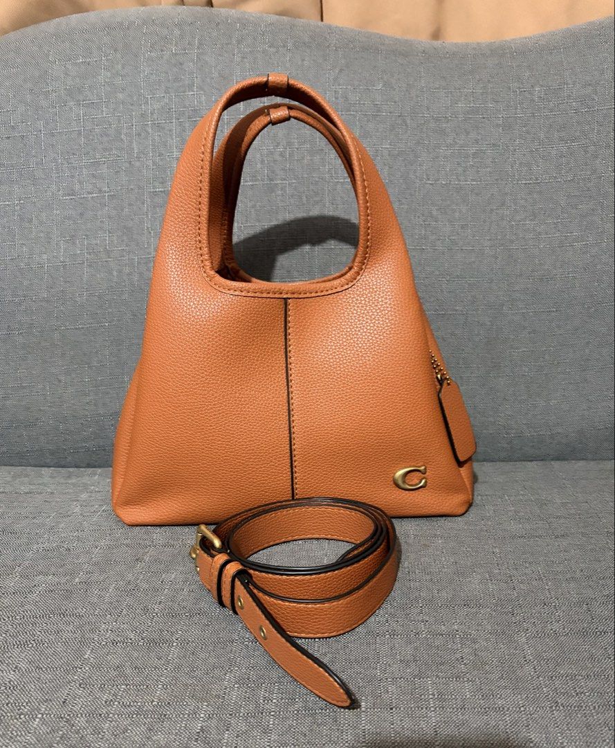 Coach Pebble Leather Shoulder Bag - Brown (Category: Luxury Bags & Wallets) located in Binan City. Submitted by shelabs29 (Listing ID 1451037260, Image 1). Description: - Brand: Coach - Material: Brown pebbled leather - Features: Top handle, detachable crossbody strap - Embellishments: Coach 'C' logo hardware, leather hangtag - Ideal for: Everyday use.