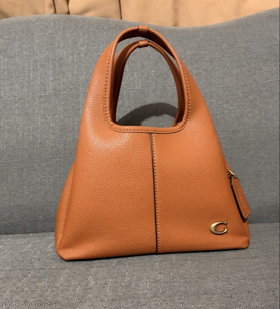 Coach Pebble Leather Shoulder Bag - Brown (Category: Luxury Bags & Wallets) located in Binan City. Submitted by shelabs29 (Listing ID 1451037260, Image 3). Description: - Brand: Coach - Material: Brown pebbled leather - Features: Top handle, detachable crossbody strap - Embellishments: Coach 'C' logo hardware, leather hangtag - Ideal for: Everyday use.