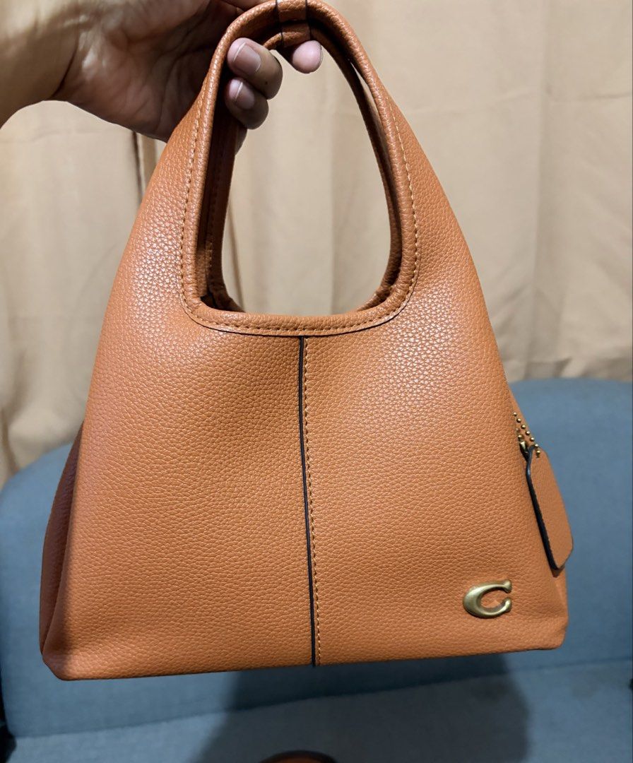 Coach Pebble Leather Shoulder Bag - Brown (Category: Luxury Bags & Wallets) located in Binan City. Submitted by shelabs29 (Listing ID 1451037260, Image 2). Description: - Brand: Coach - Material: Brown pebbled leather - Features: Top handle, detachable crossbody strap - Embellishments: Coach 'C' logo hardware, leather hangtag - Ideal for: Everyday use.