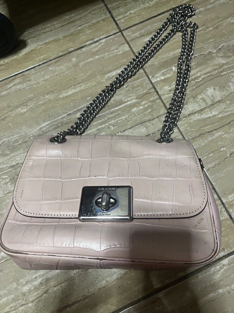 Coach Pink Croc Embossed Leather Chain Shoulder Bag (Category: Luxury Bags & Wallets) located in Caloocan City. Submitted by ericavi_g (Listing ID 1447841373, Image 2). Description: Orig bawal sa maarte pero magnda p yn pwede pang pang everyday super good dealp - Coach shoulder bag in light pink - Genuine croc-embossed leather - Secure silver turn-lock closure - Stylish chain strap - Versatile for everyday or evening wear.