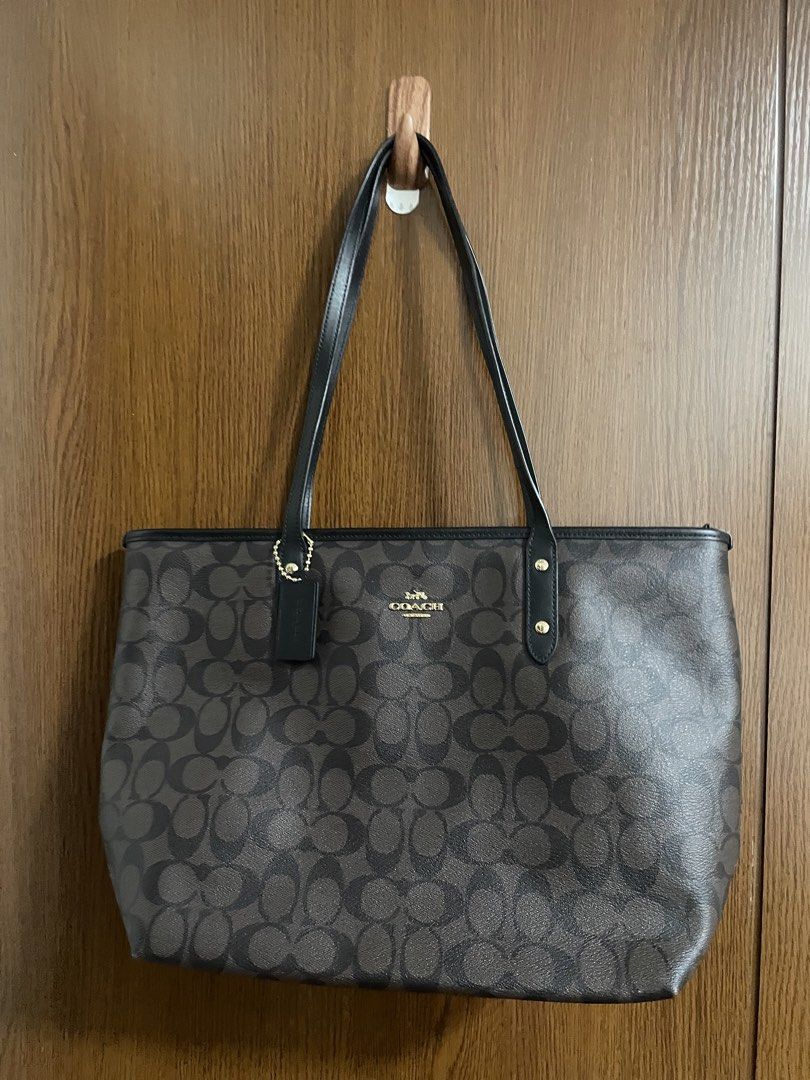 Coach Signature Leather Tote Bag (Category: Tote Bags) located in Manila. Submitted by misyeli (Listing ID 1451068914, Image 2). Description: - Classic Coach tote bag - Signature C pattern in brown and black - Genuine leather trim and handles - Secure zipper closure - Interior zip pocket and slip pockets - Spacious and ideal for everyday use - Never used , but no dust bag .