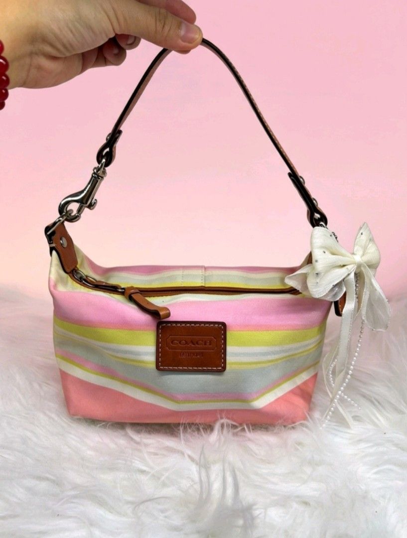 Coach Striped Canvas Mini Shoulder Bag (Category: Luxury Bags & Wallets) located in Cuyapo. Submitted by felicity_9287 (Listing ID 1451000174, Image 2). Description: Note: The buyer will shoulder the shipping fee. We ship via J&T. Payment first thru gcash 😉 - Y2K Coach Hampton Watercolor Stripe Small Mini Hobo Bag - Cute mini shoulder bag - Pastel stripe design - Features a leather Coach tag - Adorable ribbon detail - Ideal size for essentials -